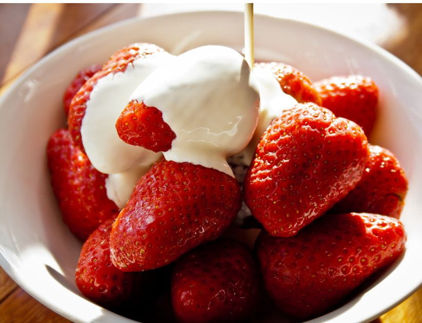 A bowl of strawberries and cream