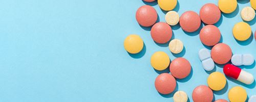 Pilled laid out on a blue background
