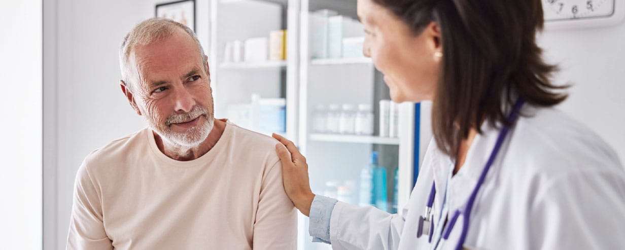 Mature man in a GP surgery talking with a Doctor