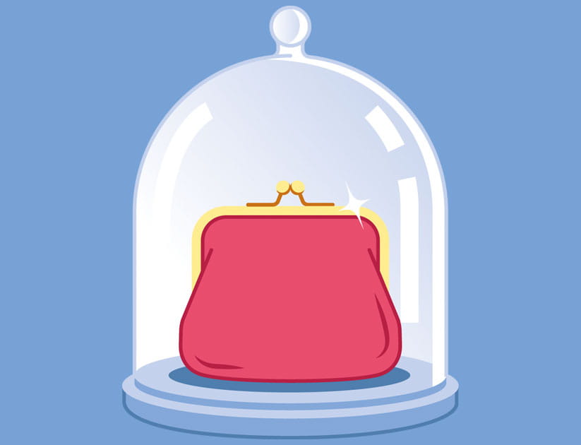 a red purse enclosed in a glass food dome
