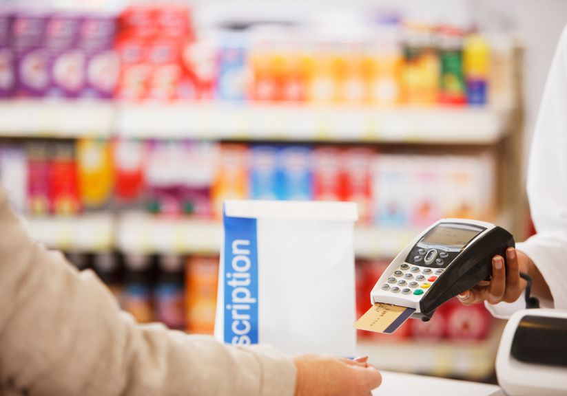 A person paying for prescriptions at a chemist