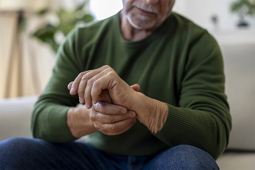 Senior Man Holding Painful Wrist at Home