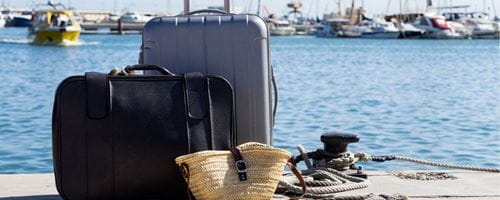  Suitcases prepared next to a pier at sea to board a passenger ship