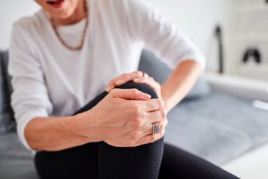 Seated person holding their bent knee
