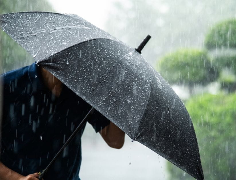 Man holding umbrella in the rain