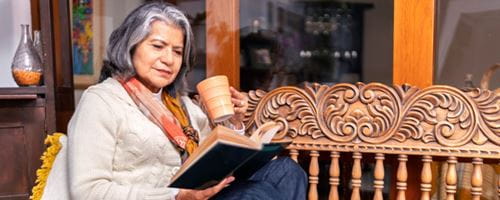 A woman enjoying a peaceful moment with a cup of tea and a captivating nook