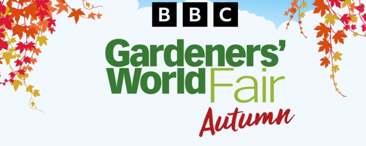 Illustration of autumn leaves bracketing text which reads: 'BBC Gardeners' World Fair Autumn' on a background with blue sky and white clouds