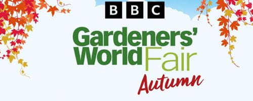Illustration of autumn leaves bracketing text which reads: 'BBC Gardeners' World Fair Autumn' on a background with blue sky and white clouds