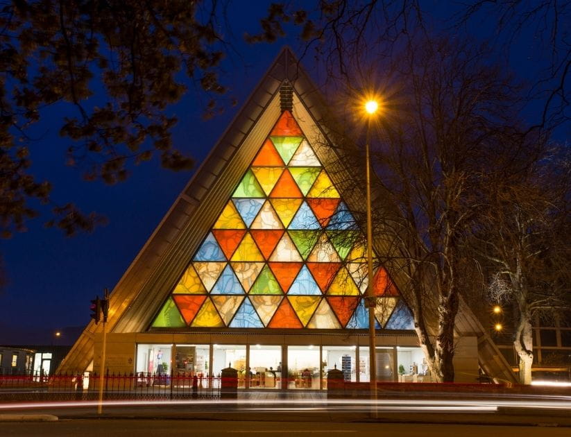 The front view of the triangle-shaped, multicoloured Cardboard Cathedral in Christchurch, New Zealand