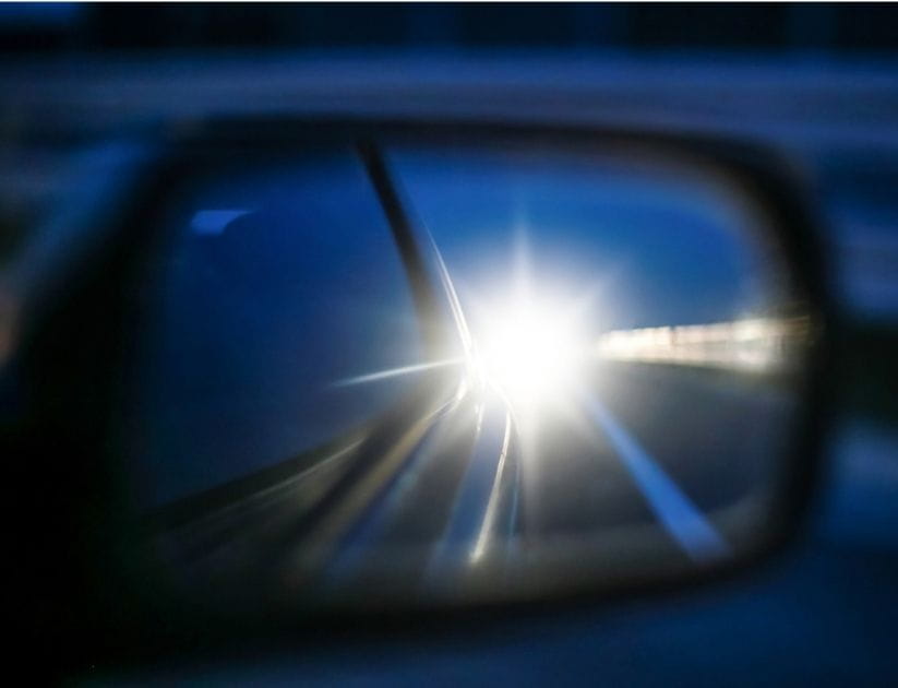Bright cars lights in rear view mirror