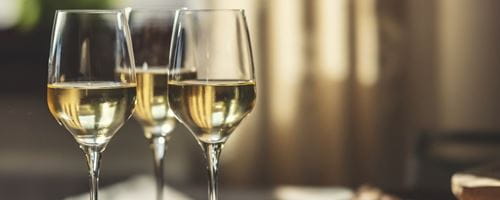 Three glasses of white wine next to eachother