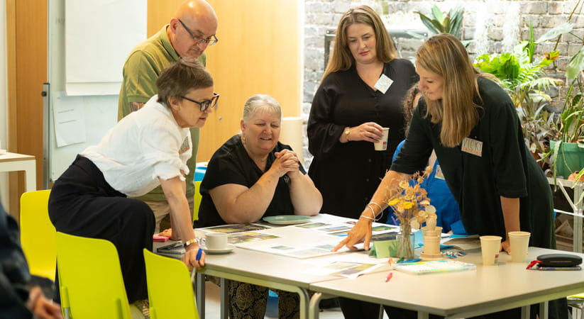 Five people around a table at a Parkinson's UK gardening workshop