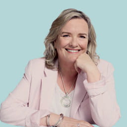 Saga Magazine Editor Louise Robinson in a light pink jacket looking at the camera