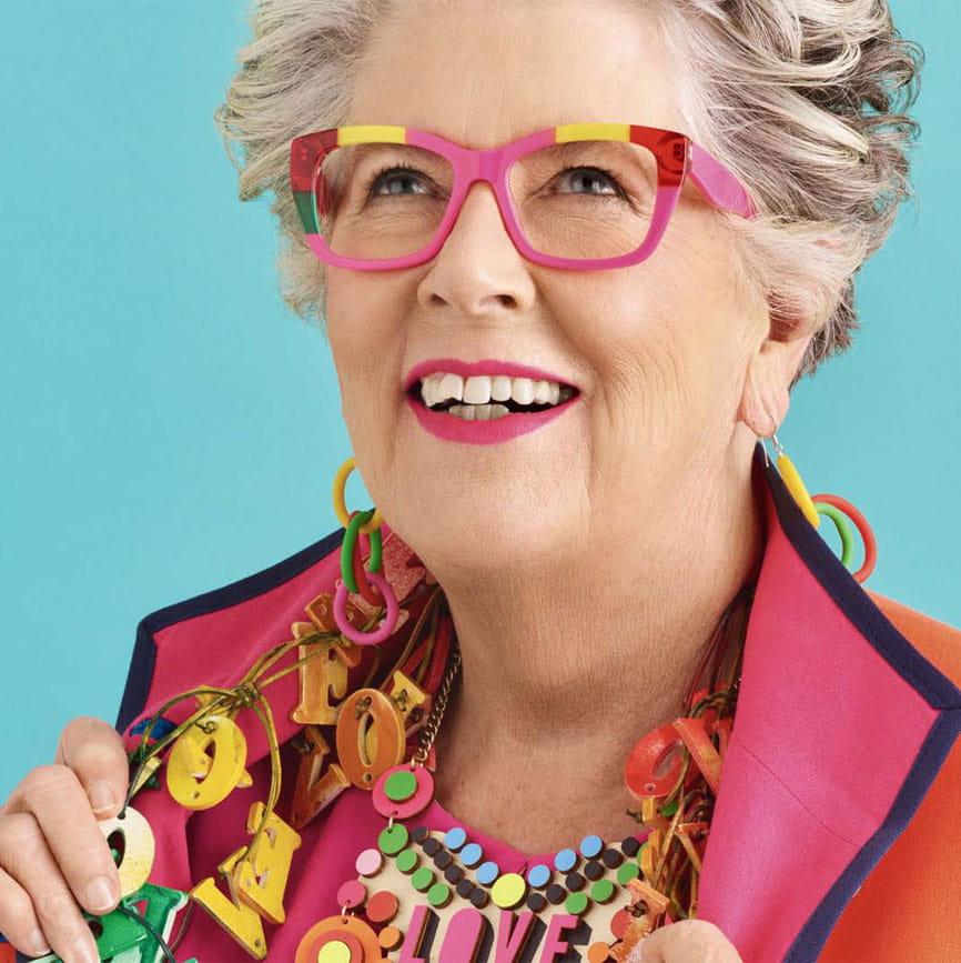 Close-up of Prue Leith smiling in her signature bright clothing