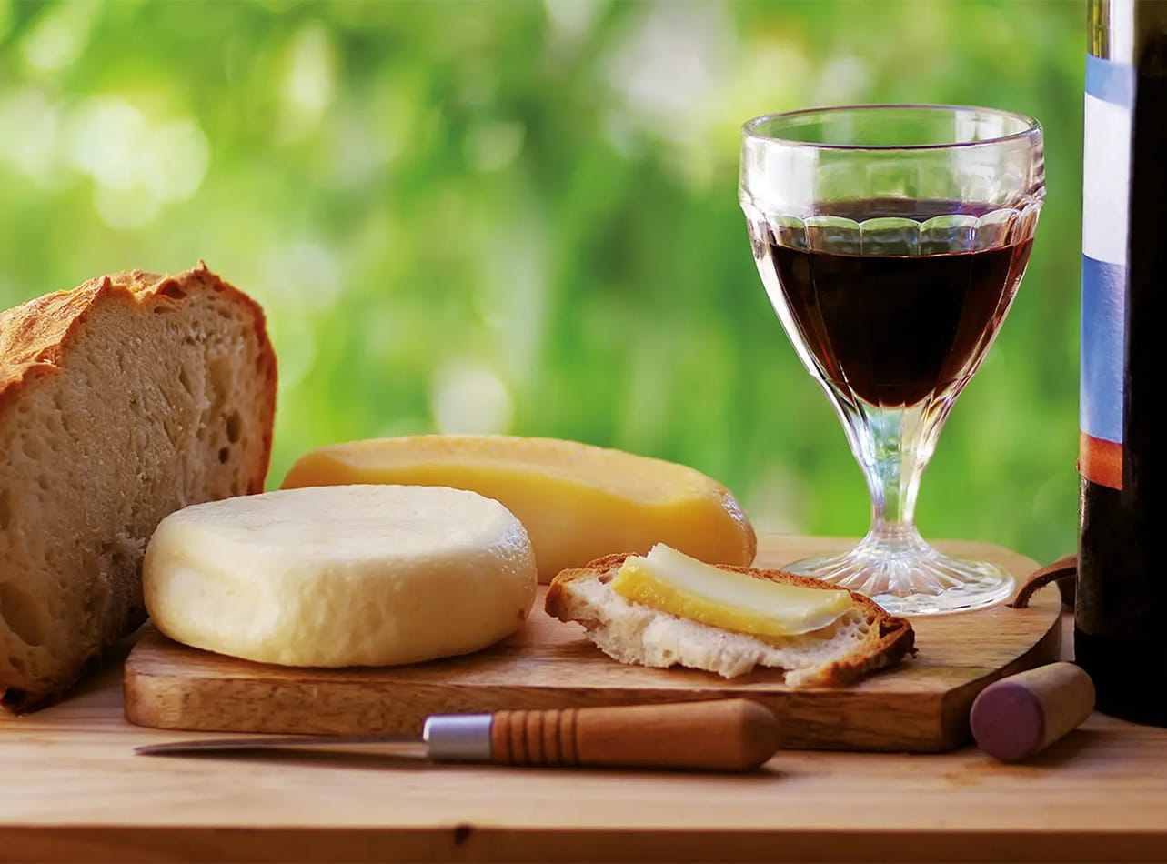 Bread, cheese and wine on a wooden board