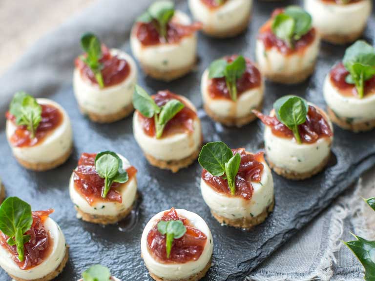Goat’s curd and watercress cheesecakes laid out on a black slate