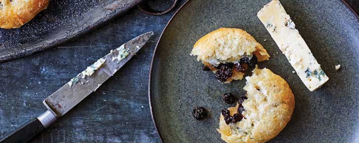 James Martin's Blackburn and Eccles cake on a plate with a knife and a slice of Stilton