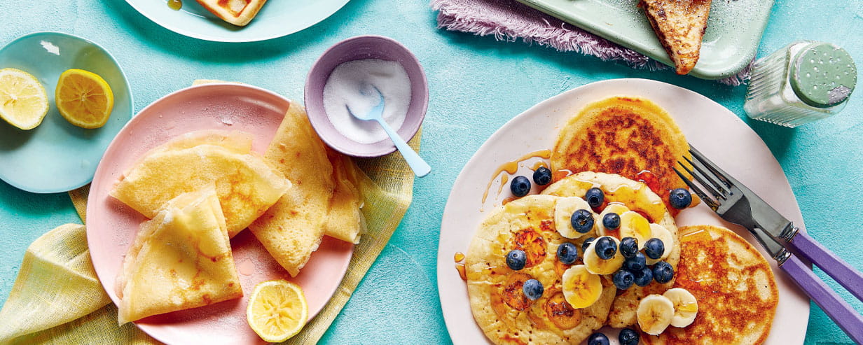 A selection of pancakes with various toppings on colourful plates