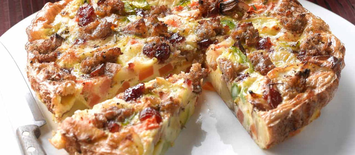 Close-up of a left-over frittata with a slice missing and another one cut out from the main