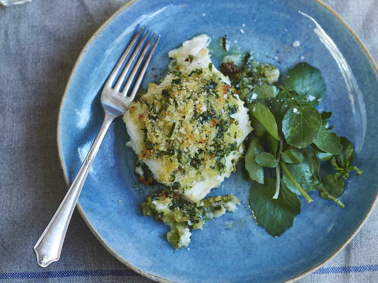 A piece of  baked cod with a herb crust