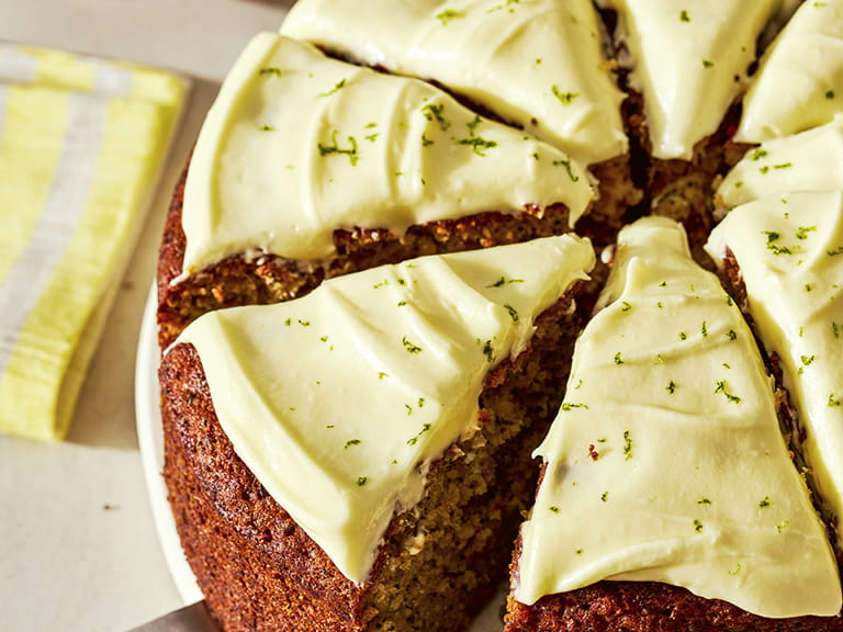 A close-up shot of a courgette and lime cake sliced into sections