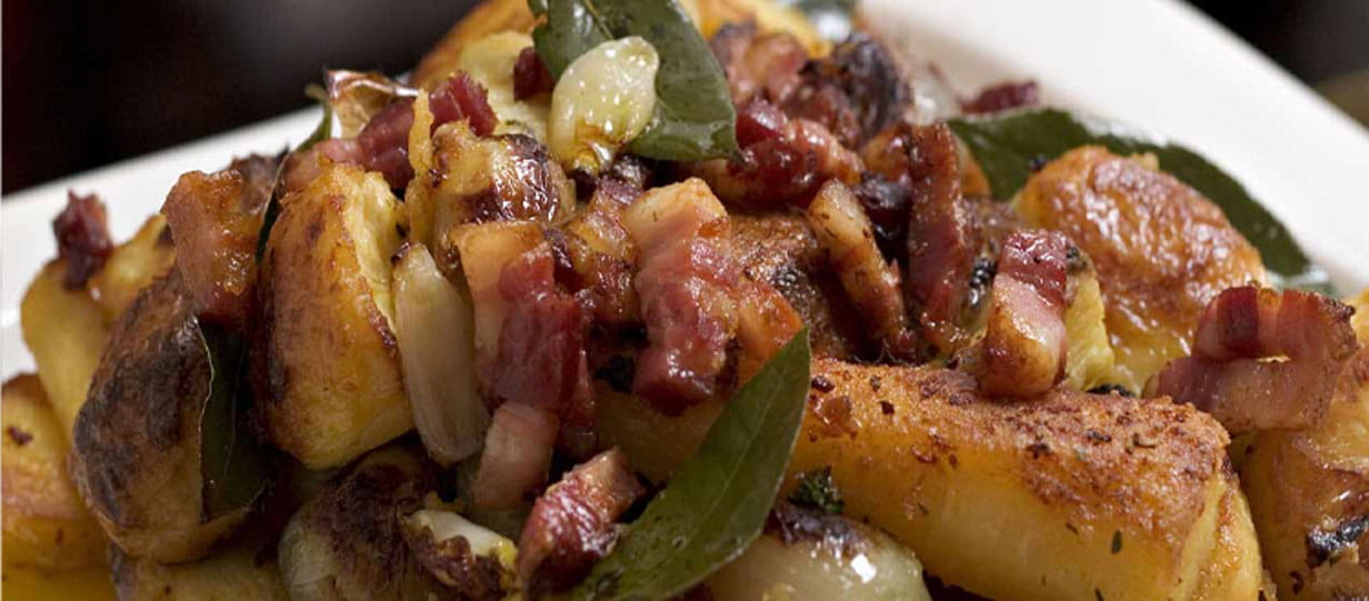 Roast potatoes, parsnips and shallots with pancetta and bay leaves