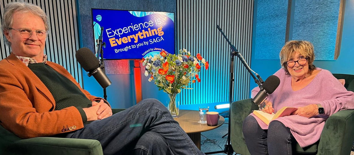 Paul and Jenny recording a podcast with 'Experience is Everything' logo on the screen behind them