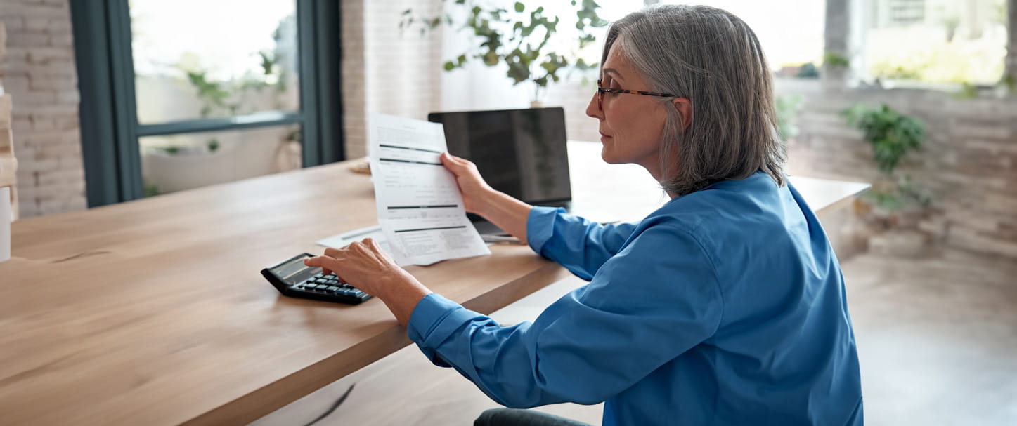 A woman sat at a desk looking at paperwork