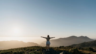 A woman looking out across a mountain range