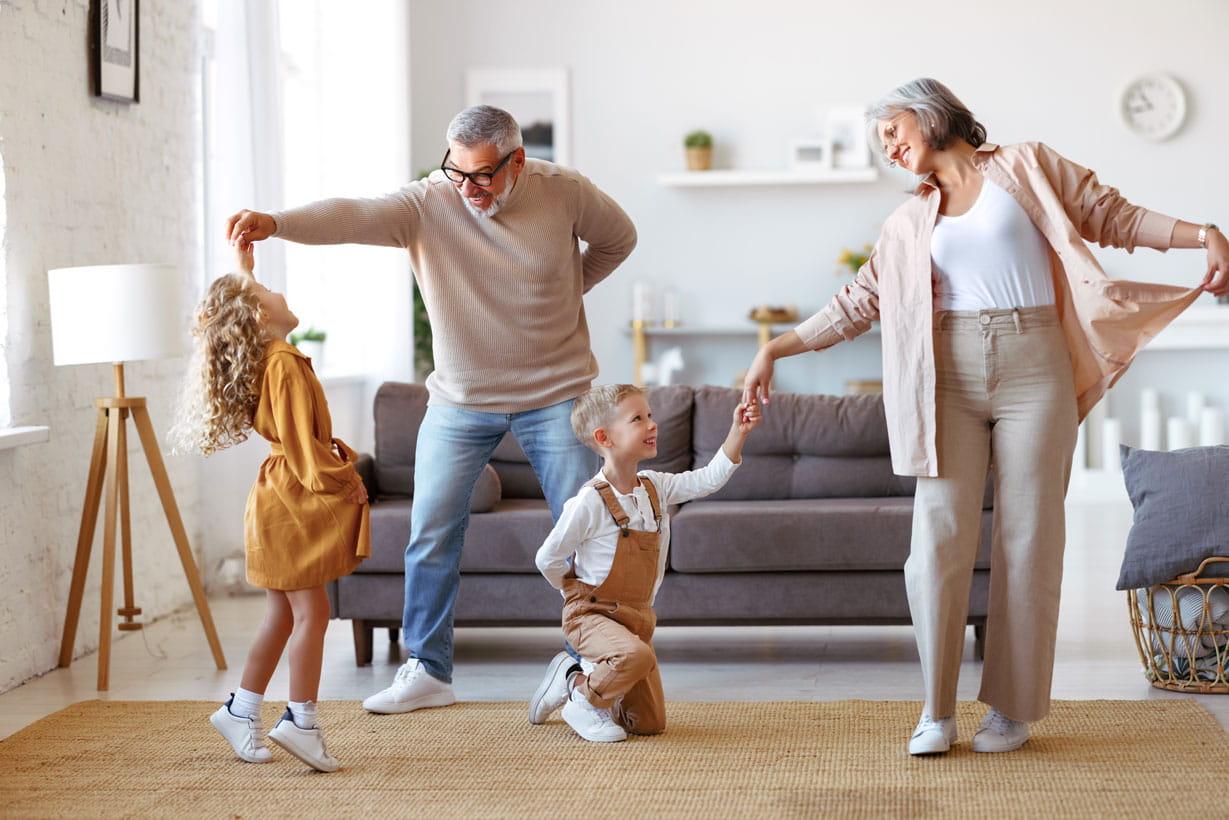 Grandparents dancing with their grandchildren