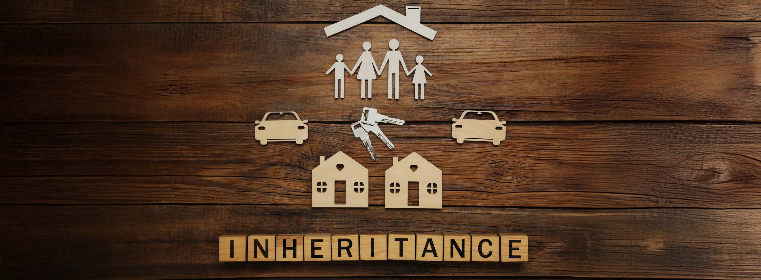 Word Inheritance made with cubes and different cutouts on wooden background, flat lay