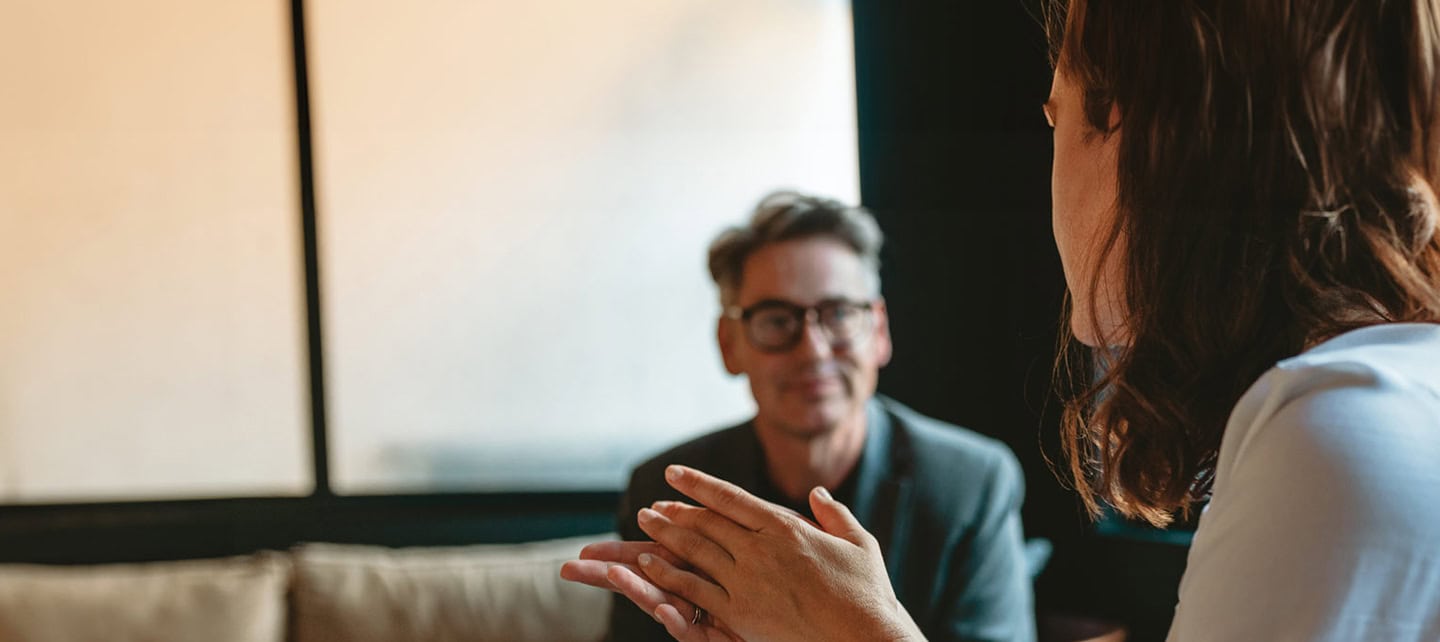 A man and woman sat talking