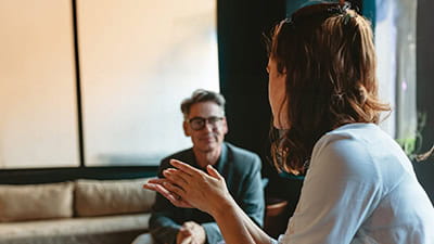 A man and woman sat talking