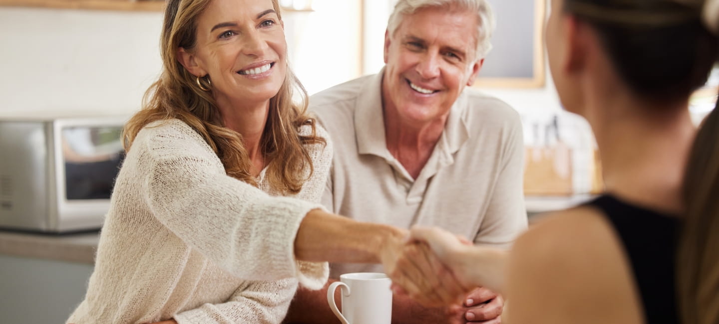 A lady shaking hands with another lady