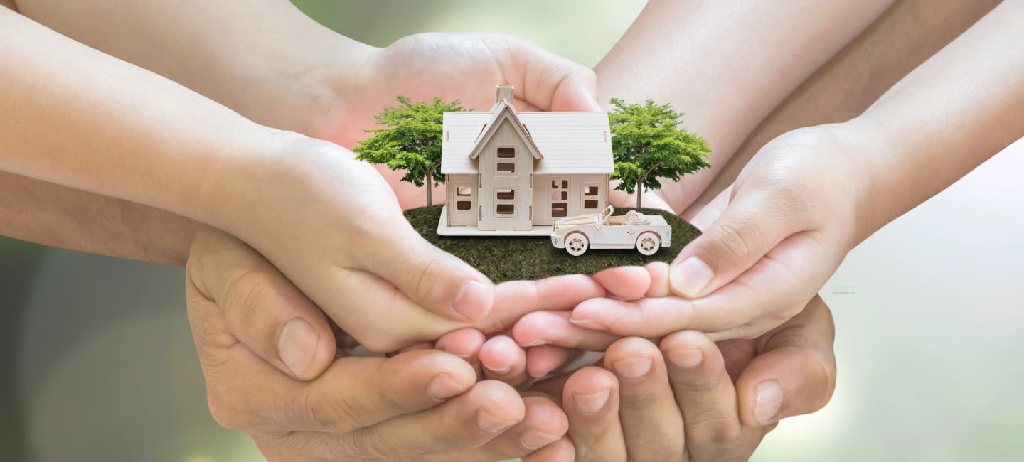 Lots of hands holding a miniature house and car