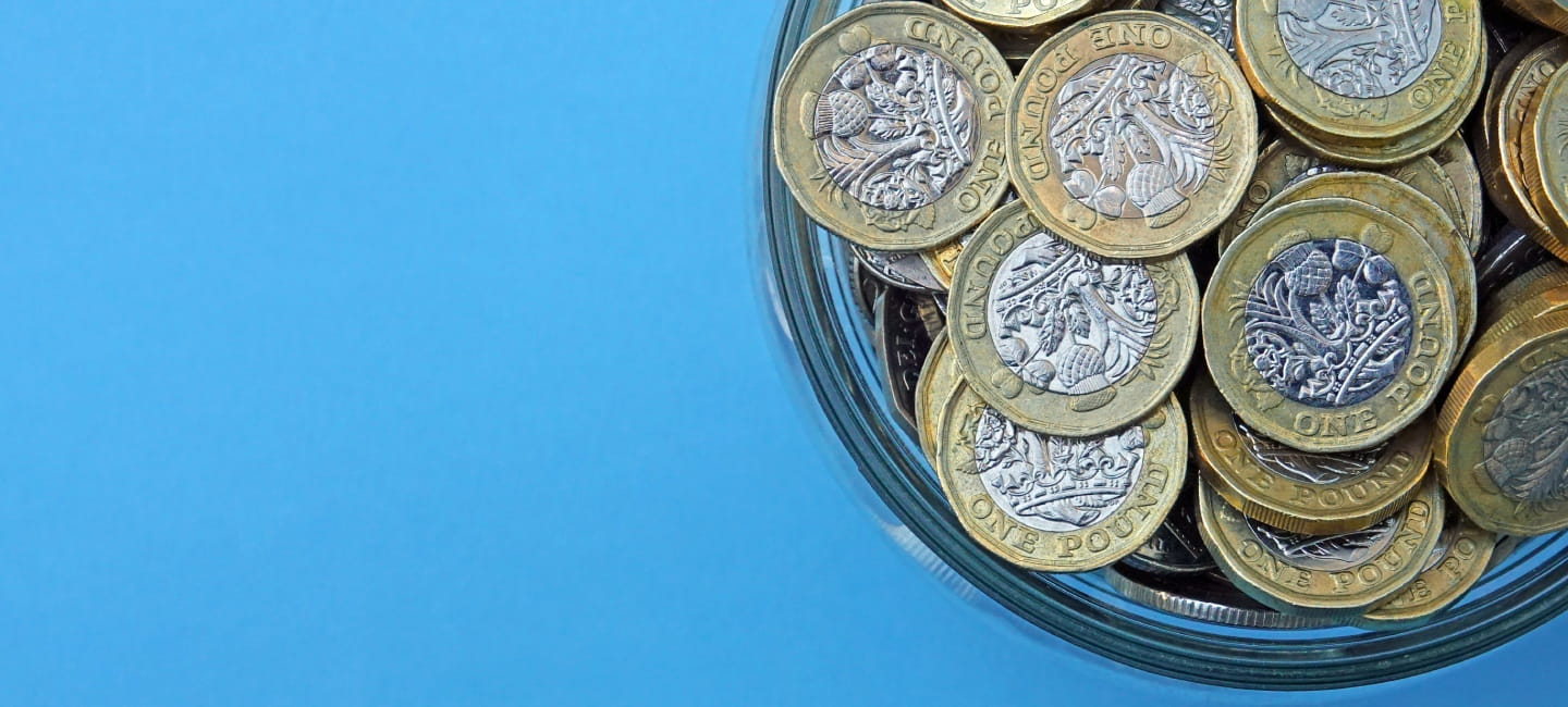 Pound coins in a cup