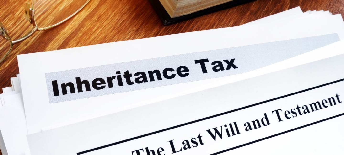 Inheritance tax and last will on the desk.