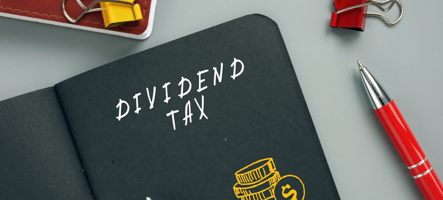 Business concept meaning DIVIDEND TAX with inscription on the page. AÂ dividend tax is a tax imposed by a jurisdiction on dividends paid by a corporation to its shareholders.