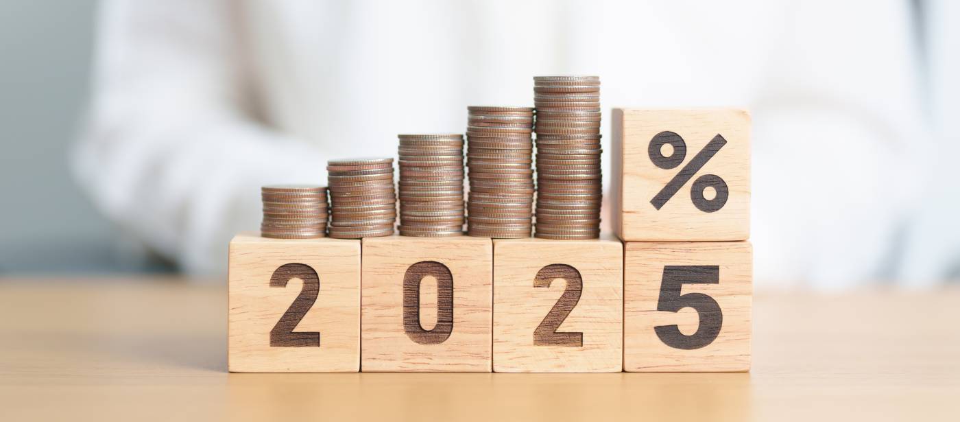 2025 year placed in wooden blocks with percentage and coins stack