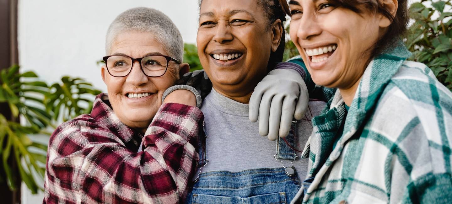 Multiracial senior women gardening outdoor in home backyard terrace .