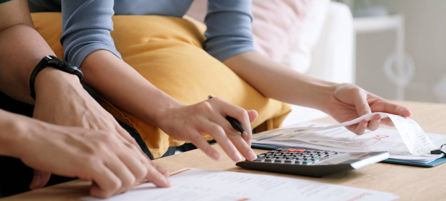 a couple with a calculator working out their bills
