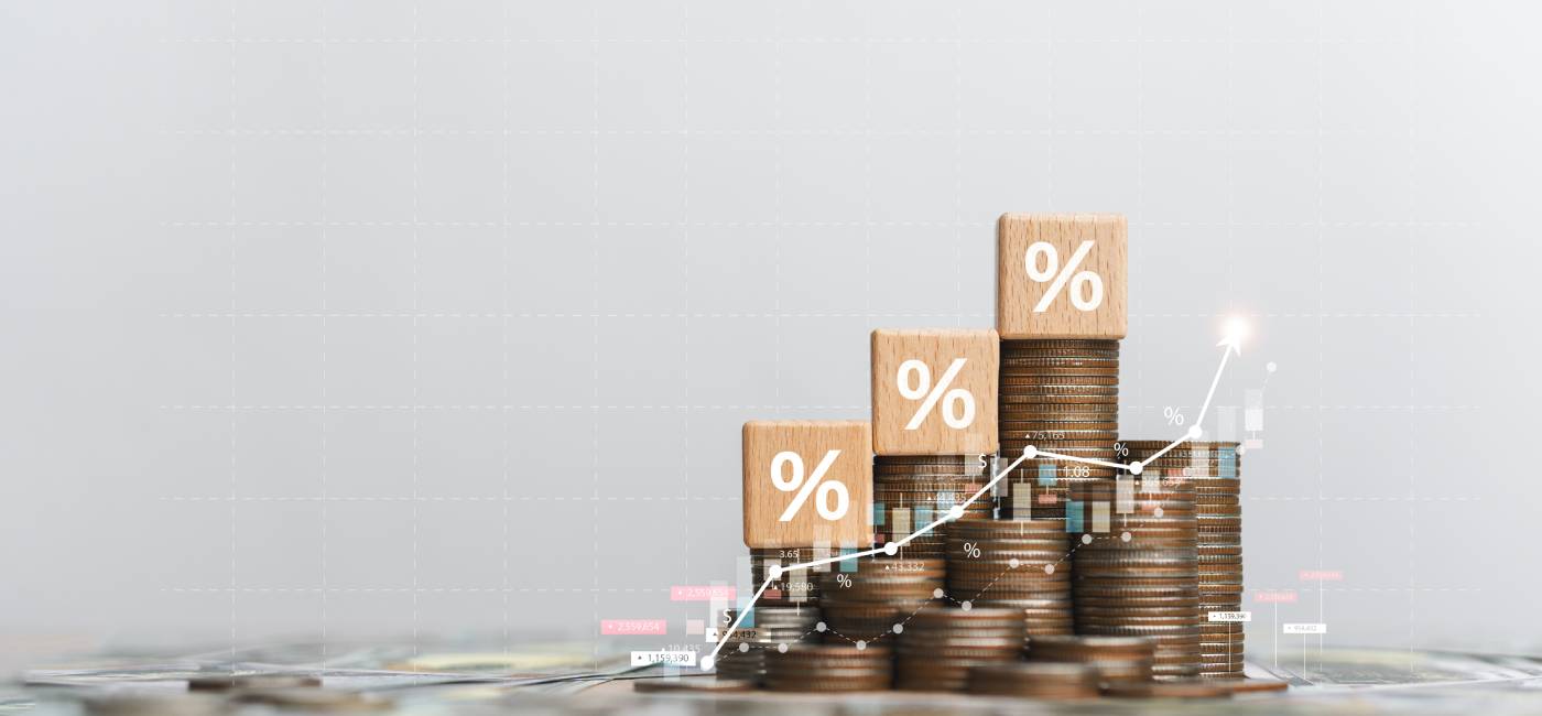 Stack of silver coins with up arrow. 