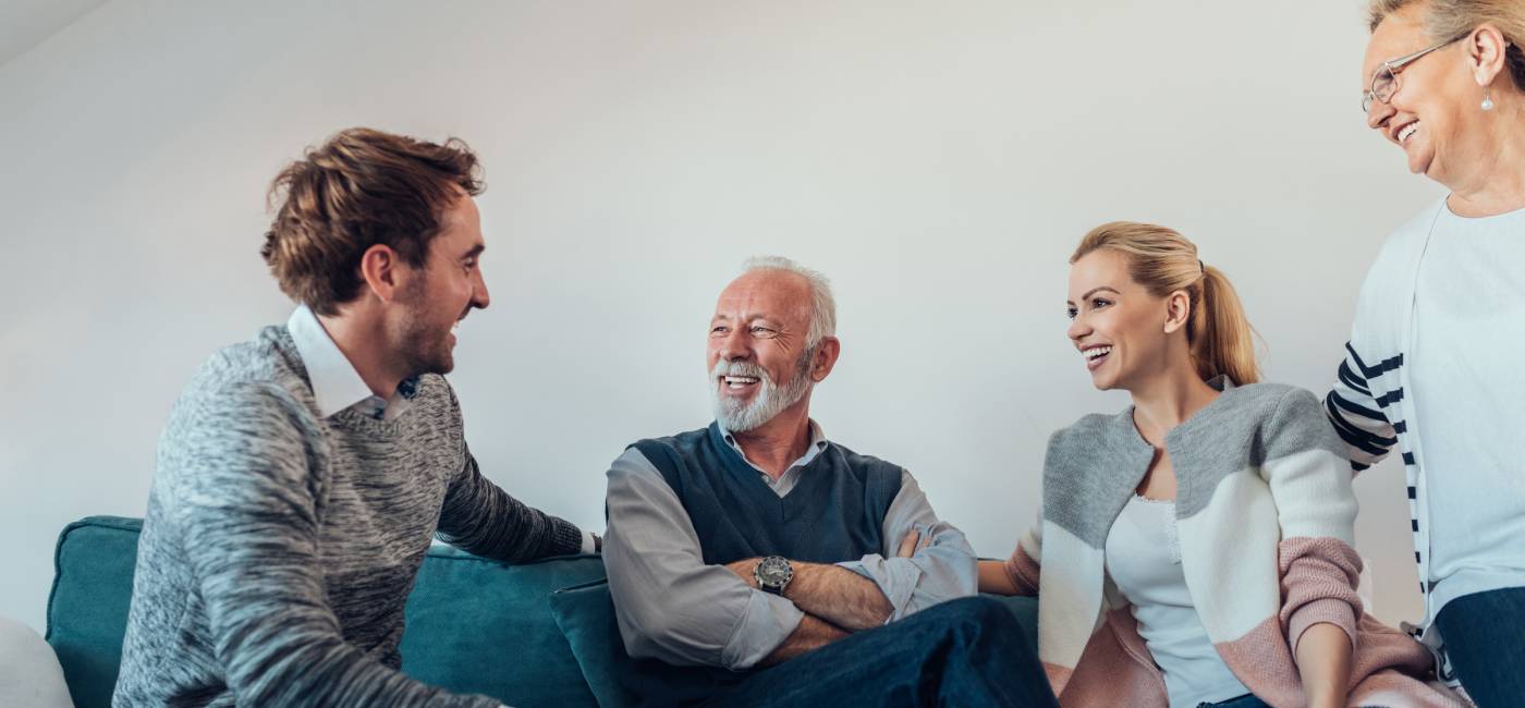 Young couple talking with their parents