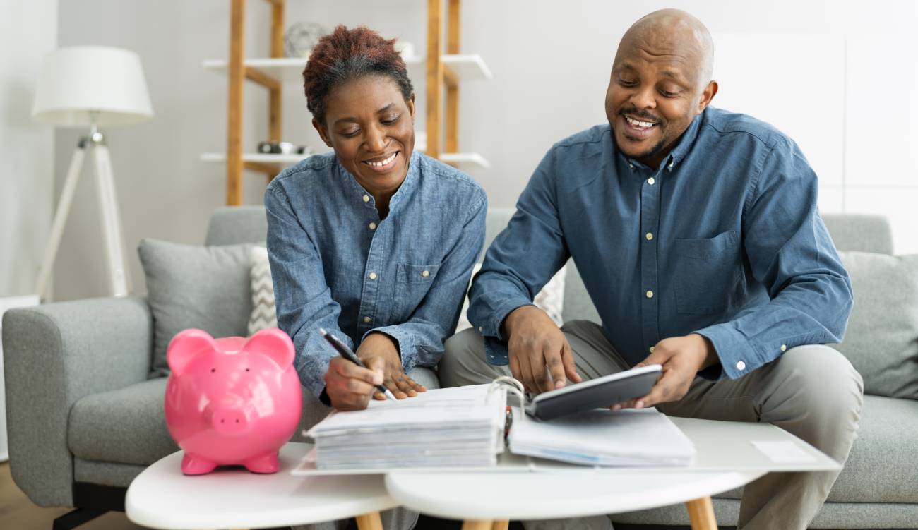 Happy African Couple Doing Retire Finances Plan And Money Budget