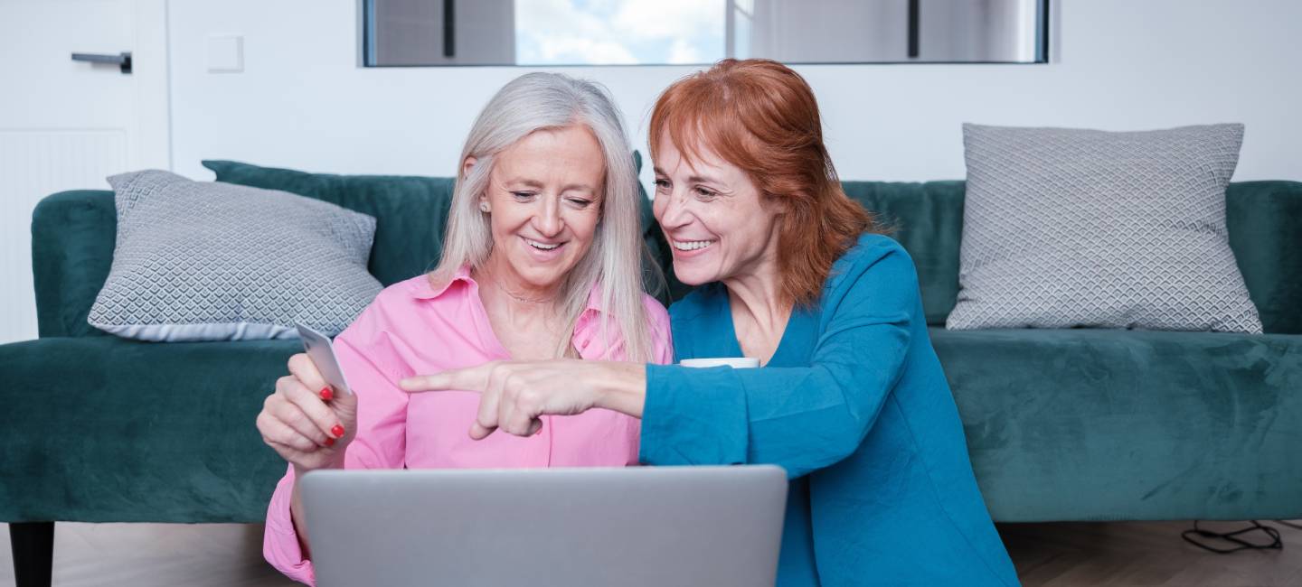 Senior LGTBI couple shopping online together. 