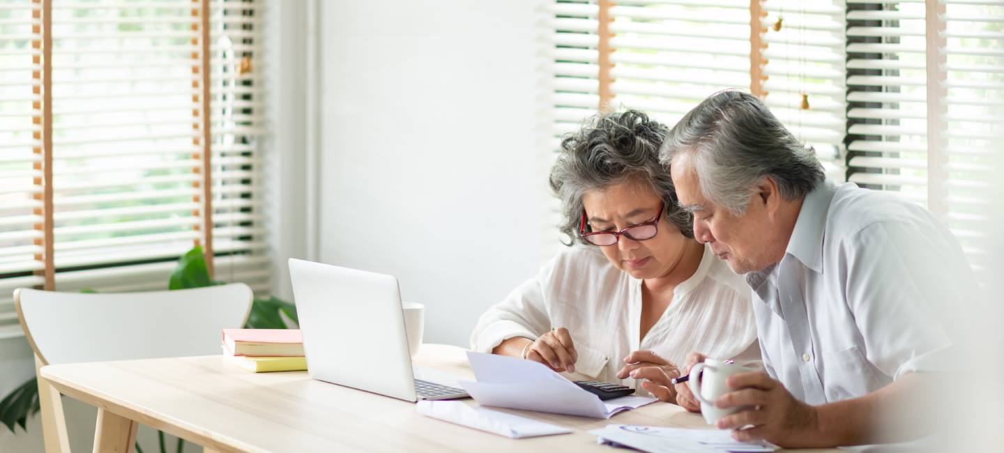 Asian Senior Couple using calculator and calculate family budget, Debts and monthly expenses