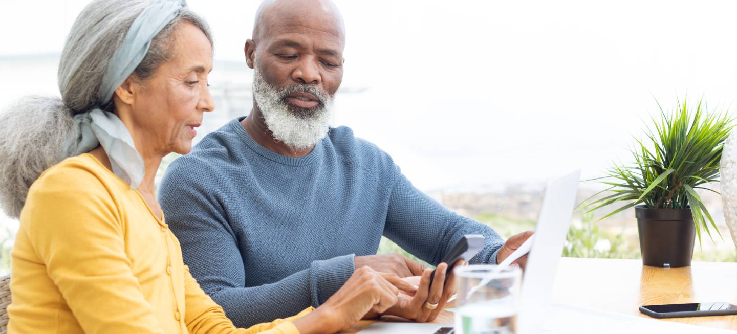 Side view of African American Couple calculating finances. Authentic Senior Retired Life Concept