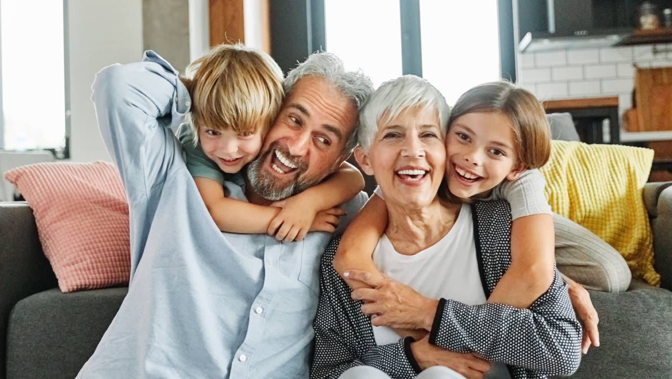 Portrait of grandparents and grandchildren having fun together at home