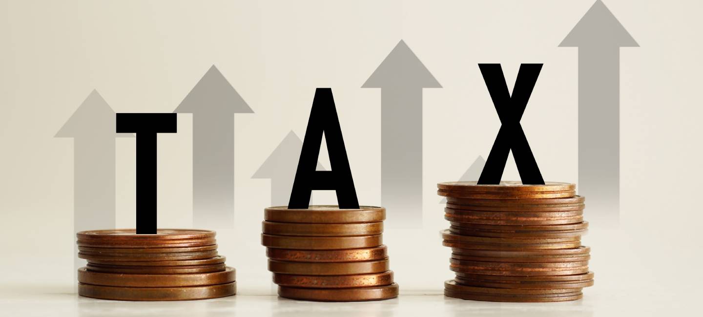 Copper coins with the word TAX and arrows pointing up