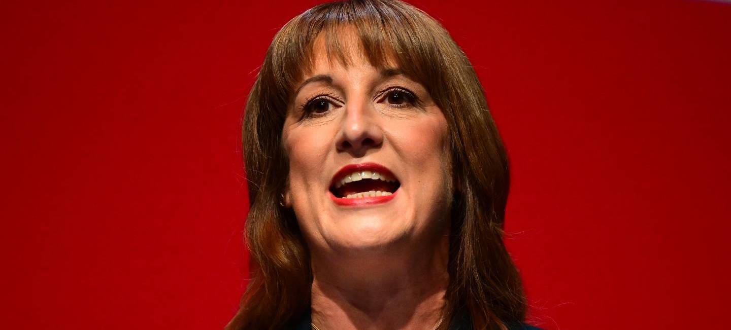 Rachel reeves in front of a red background